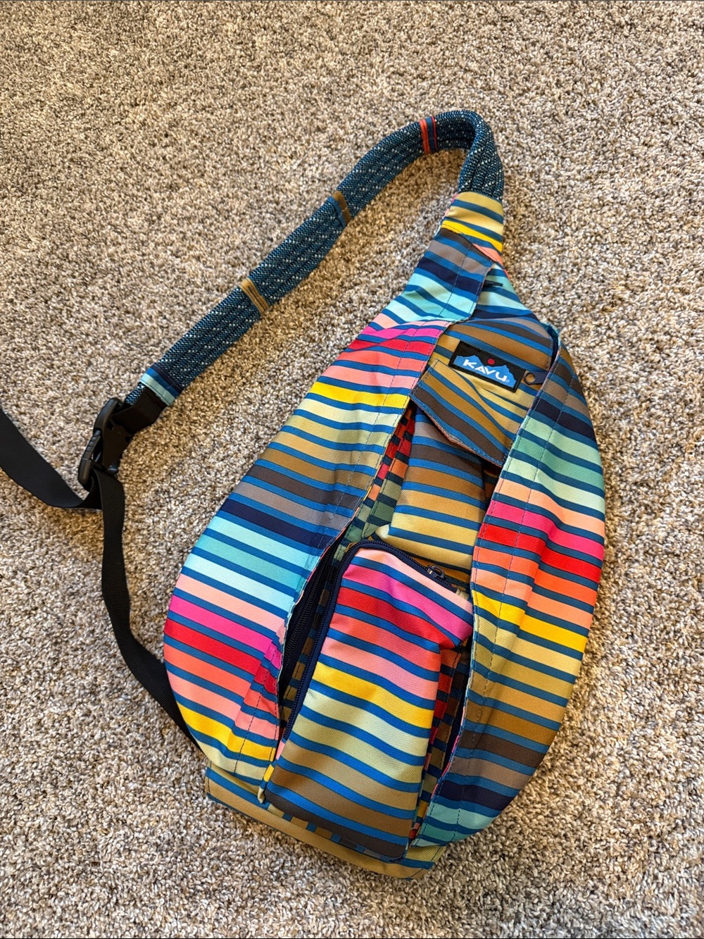 Kavu Rainbow Striped Sling Bag in Blue, Yellow, Pink & Green
